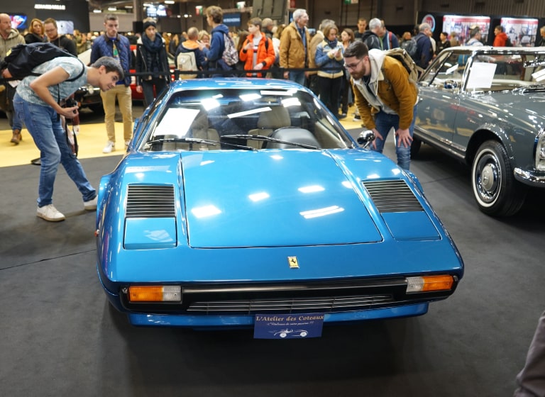 A Ferrari 308 in azzuro blue at a historic car fair