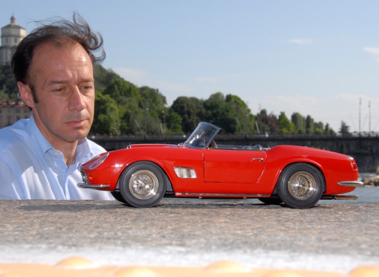 Maurizio Conti looks at his handcrafted Ferrari 250 GT Spyder model